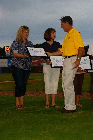 In July, Mrs. Stewart accepts a scholarship award for Benjamin Stewart, top high school scholar.